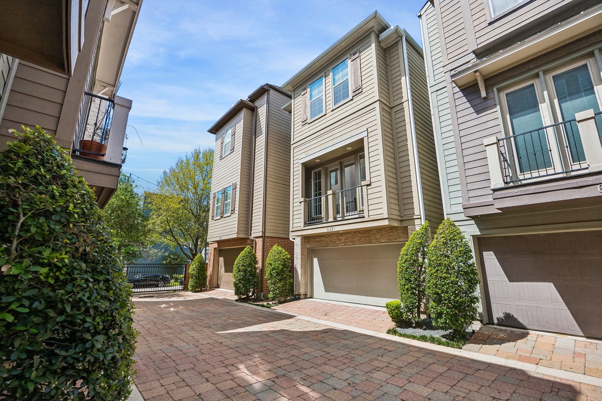 622 Rutland Street, Unit D Houston, TX 77007 - Photo 22 of 27 Private gated entrance leads to a quiet and well-kept community of similar homes. Brick-paved drive and thoughtful landscaping create a welcoming arrival. Ideal lock-and-leave lifestyle in a secure setting.
