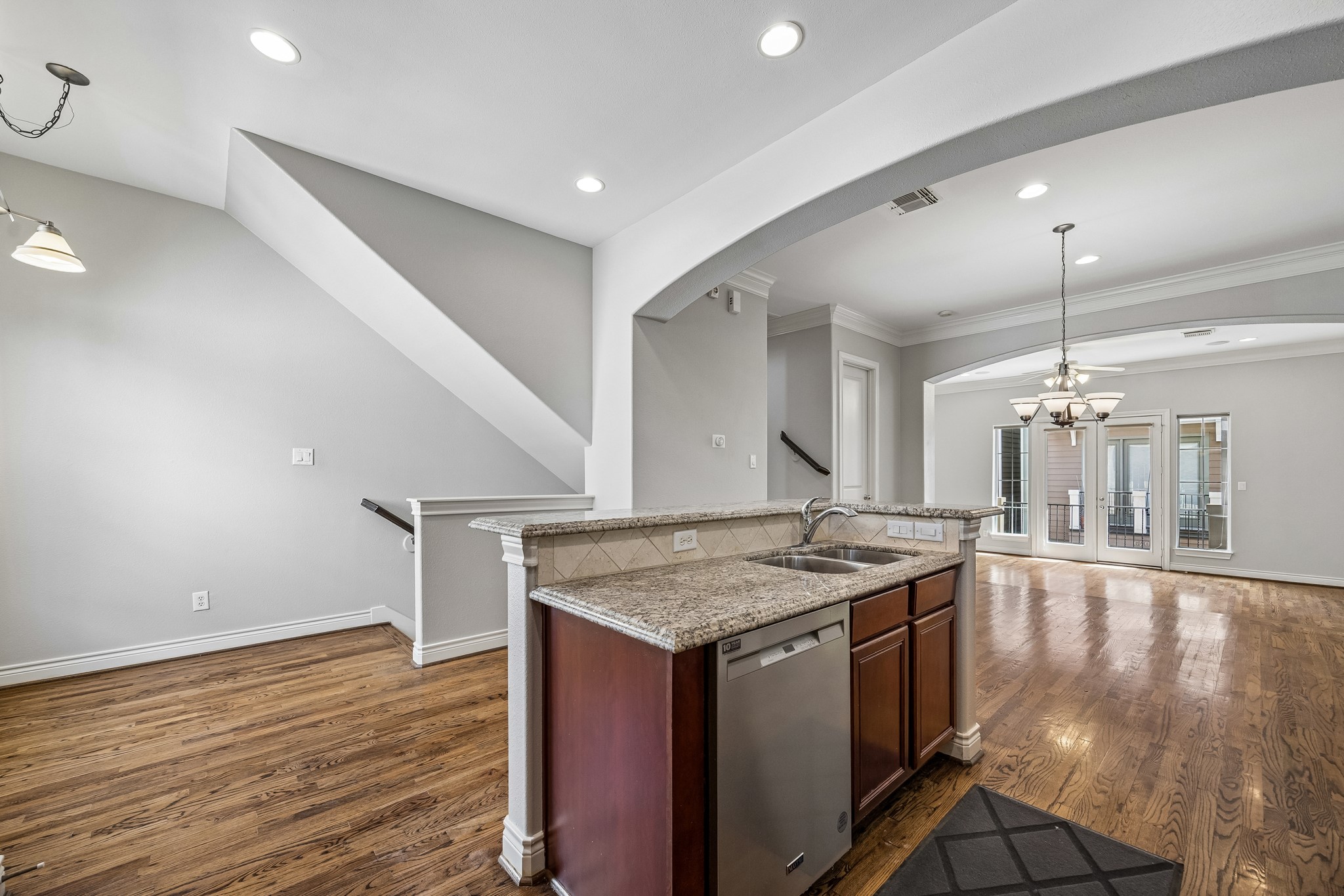 622 Rutland Street, Unit D Houston, TX 77007 - Photo 7 of 27 Open-concept living with a seamless connection between kitchen, dining, and living areas. Granite countertops, breakfast bar, and hardwood floors create a functional and inviting space. Perfect layout for both entertaining and everyday living.