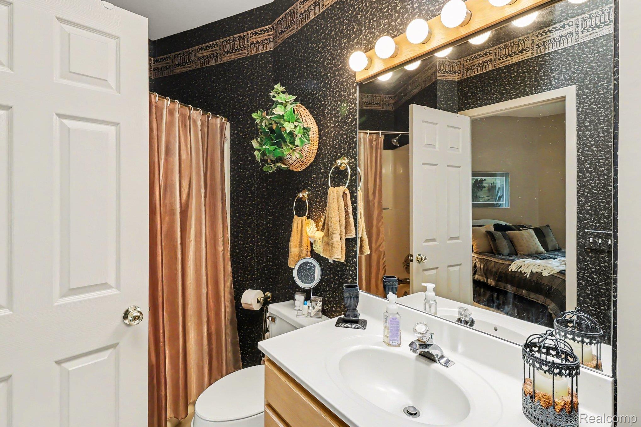 18501 Taylor Lake Road Holly, MI 48442 - Photo 22 of 35 Bathroom vanity with a white countertop and integrated sink basin