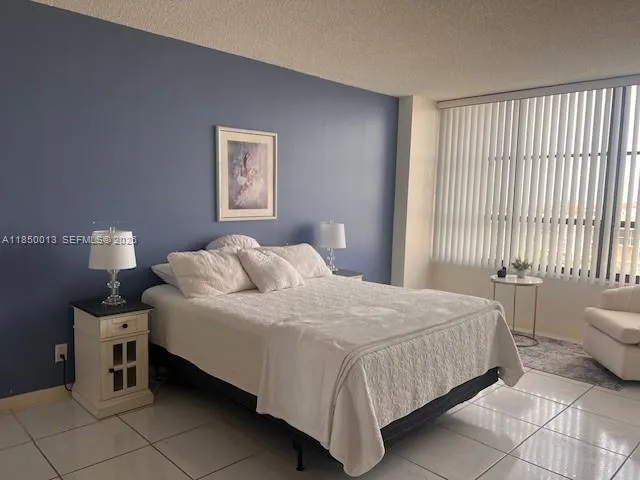 a bedroom with a bed and a lamp