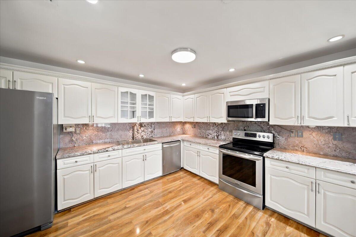 20009 Northwest 66th Place Hialeah, FL 33015 - Photo 14 of 33 a kitchen with stainless steel appliances granite countertop a stove sink and cabinets
