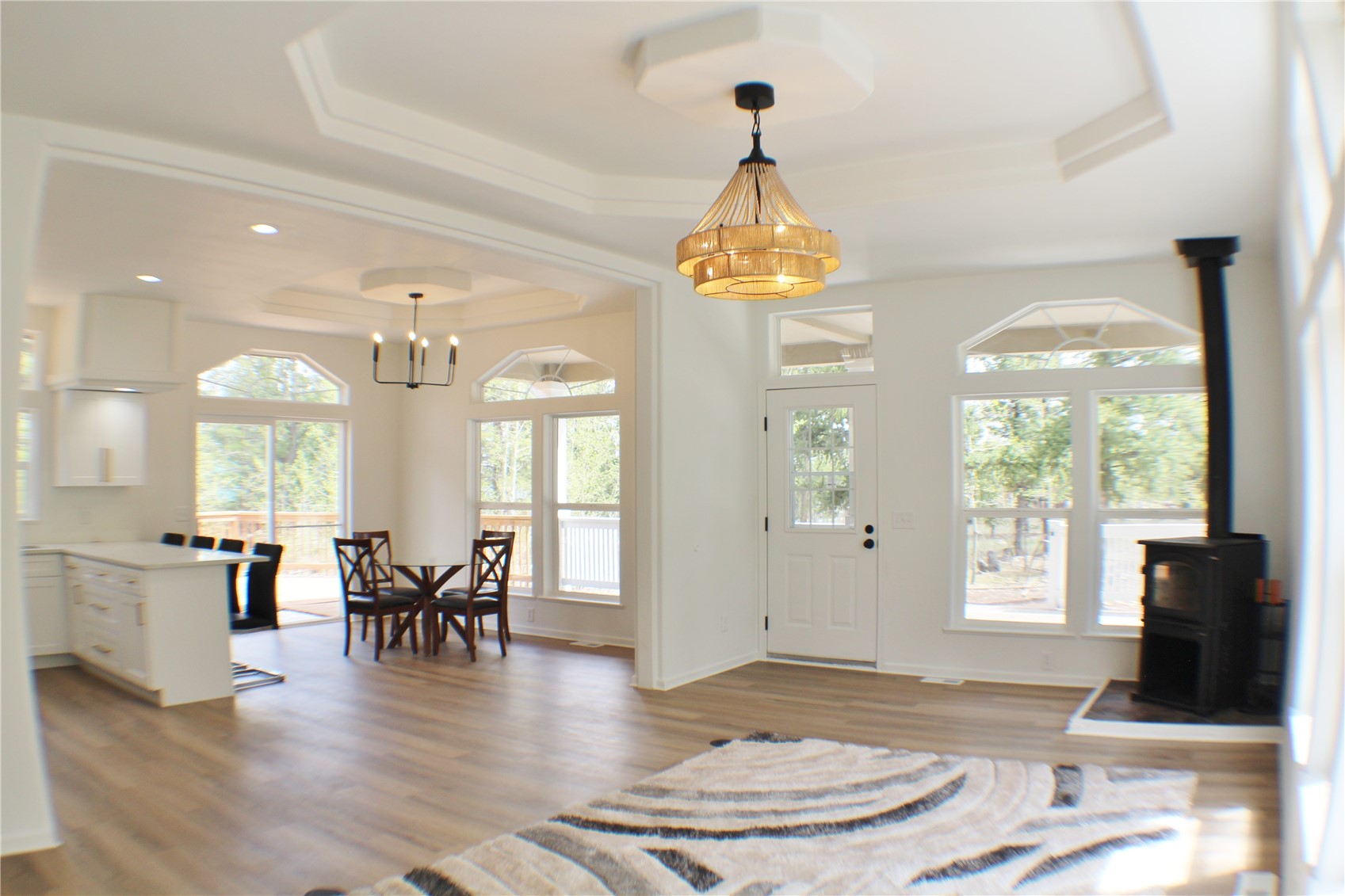 2095 Mullenville Road Fairplay, CO 80440 - Photo 5 of 22 a view of a dining room and livingroom with furniture wooden floor a chandelier