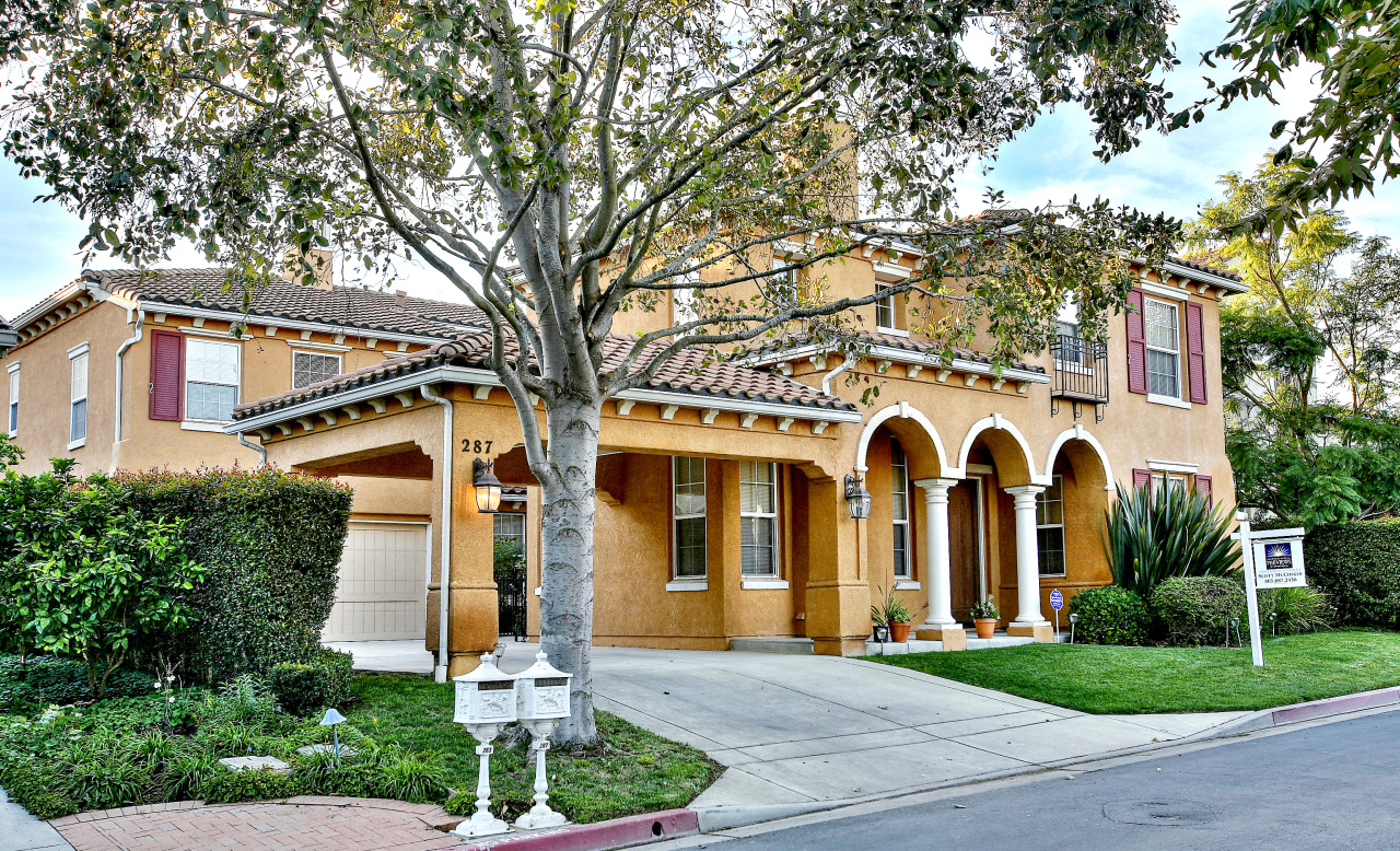 front view of a white house with a yard