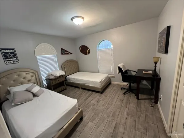 a living room with furniture and a mirror