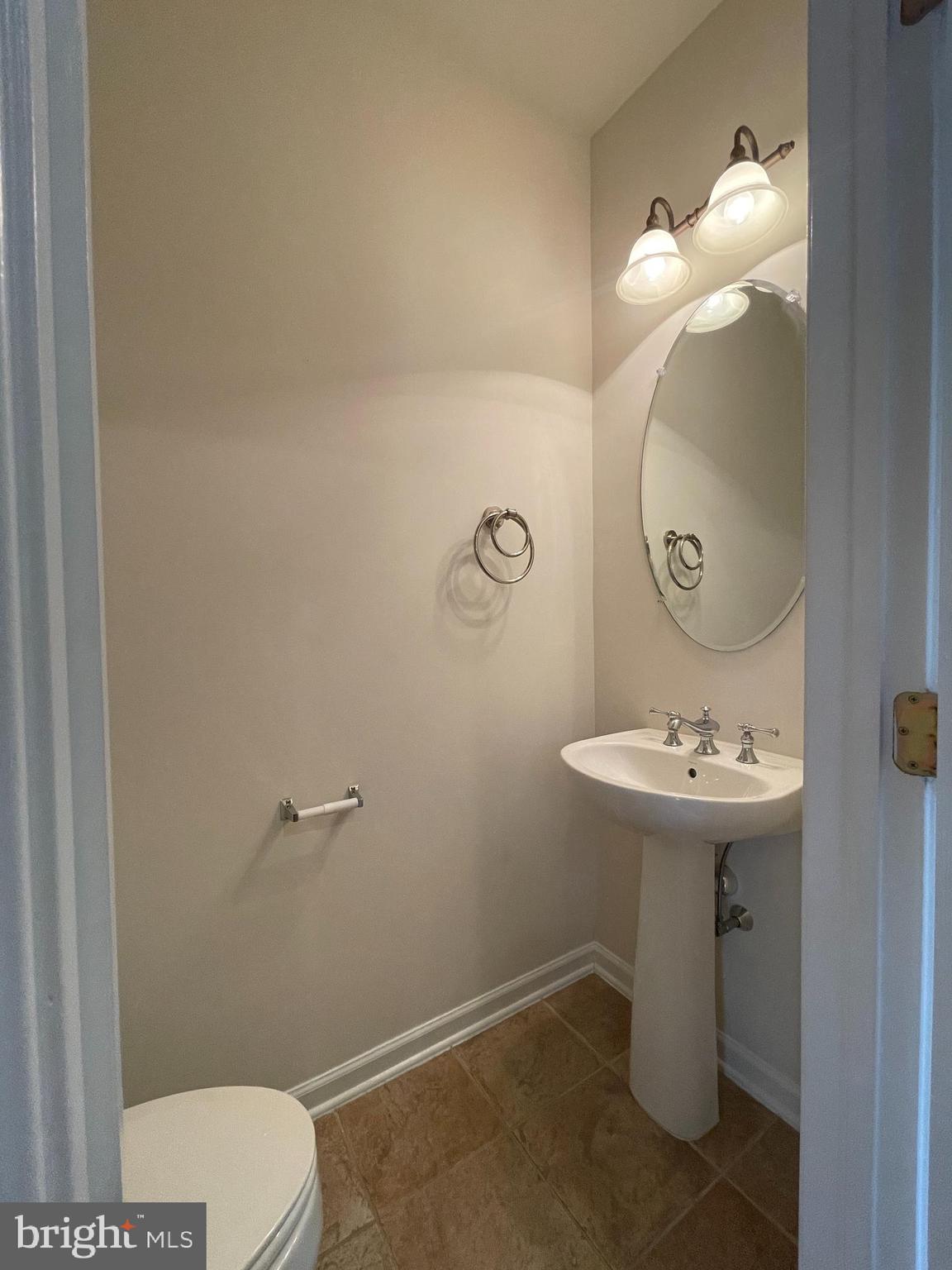 25111 Monteith Terrace Chantilly, VA 20152 - Photo 19 of 34 a bathroom with a sink a toilet and mirror