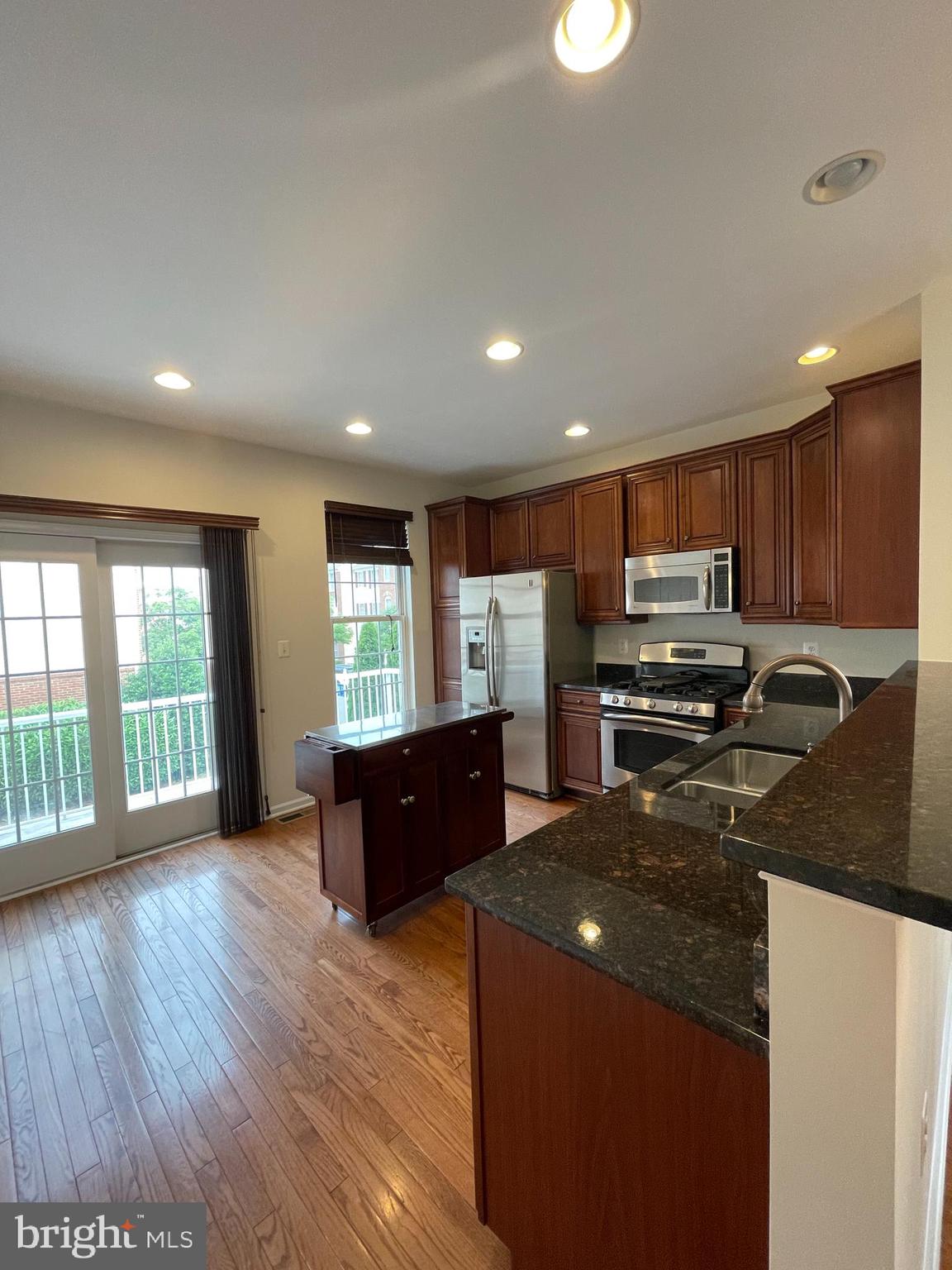 25111 Monteith Terrace Chantilly, VA 20152 - Photo 6 of 34 a kitchen with stainless steel appliances granite countertop a refrigerator a sink dishwasher a stove and a refrigerator with wooden floor
