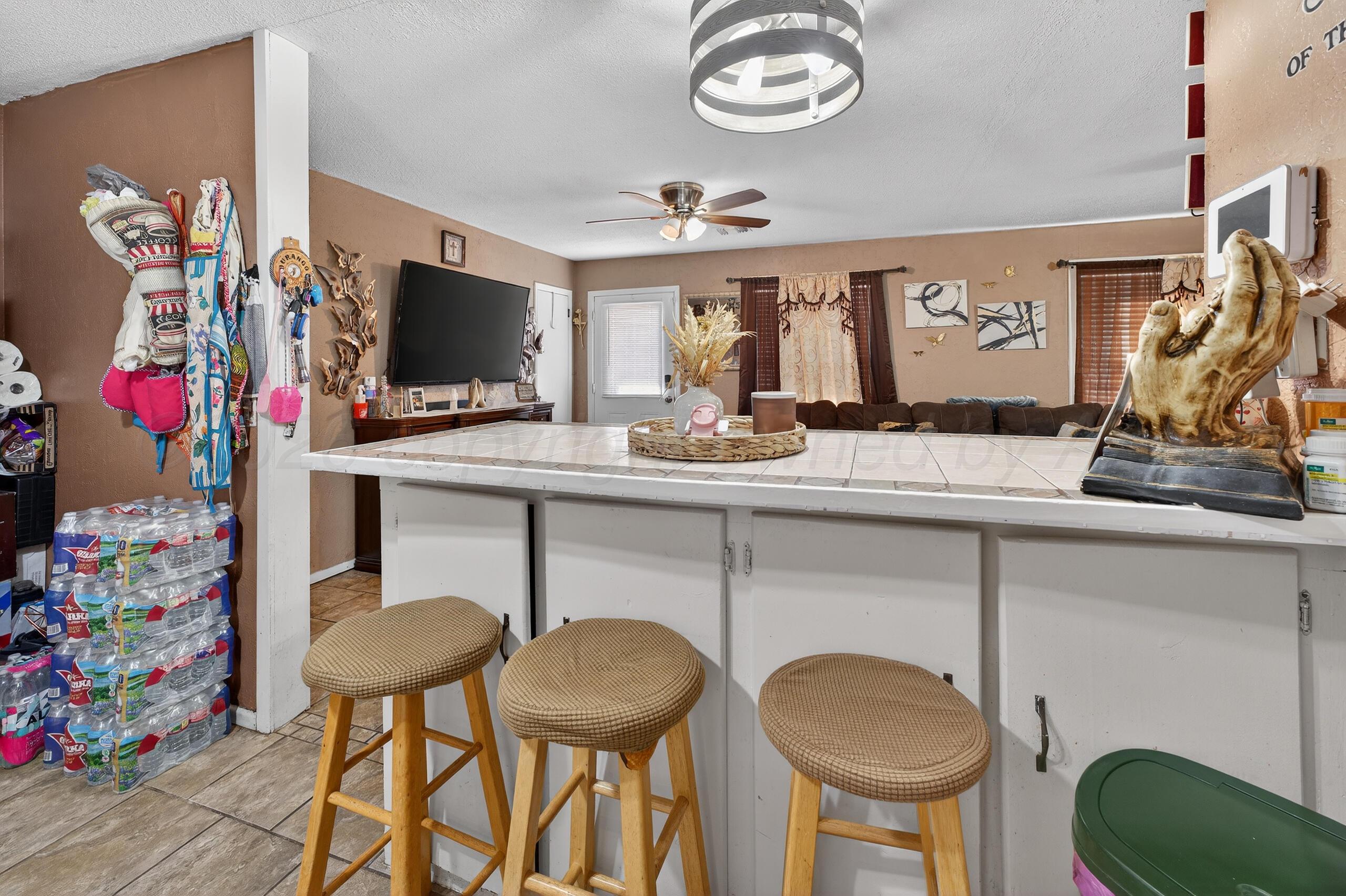 1007 Tudor Drive Amarillo, TX 79104 - Photo 11 of 27 a kitchen with stainless steel appliances granite countertop a sink and a refrigerator