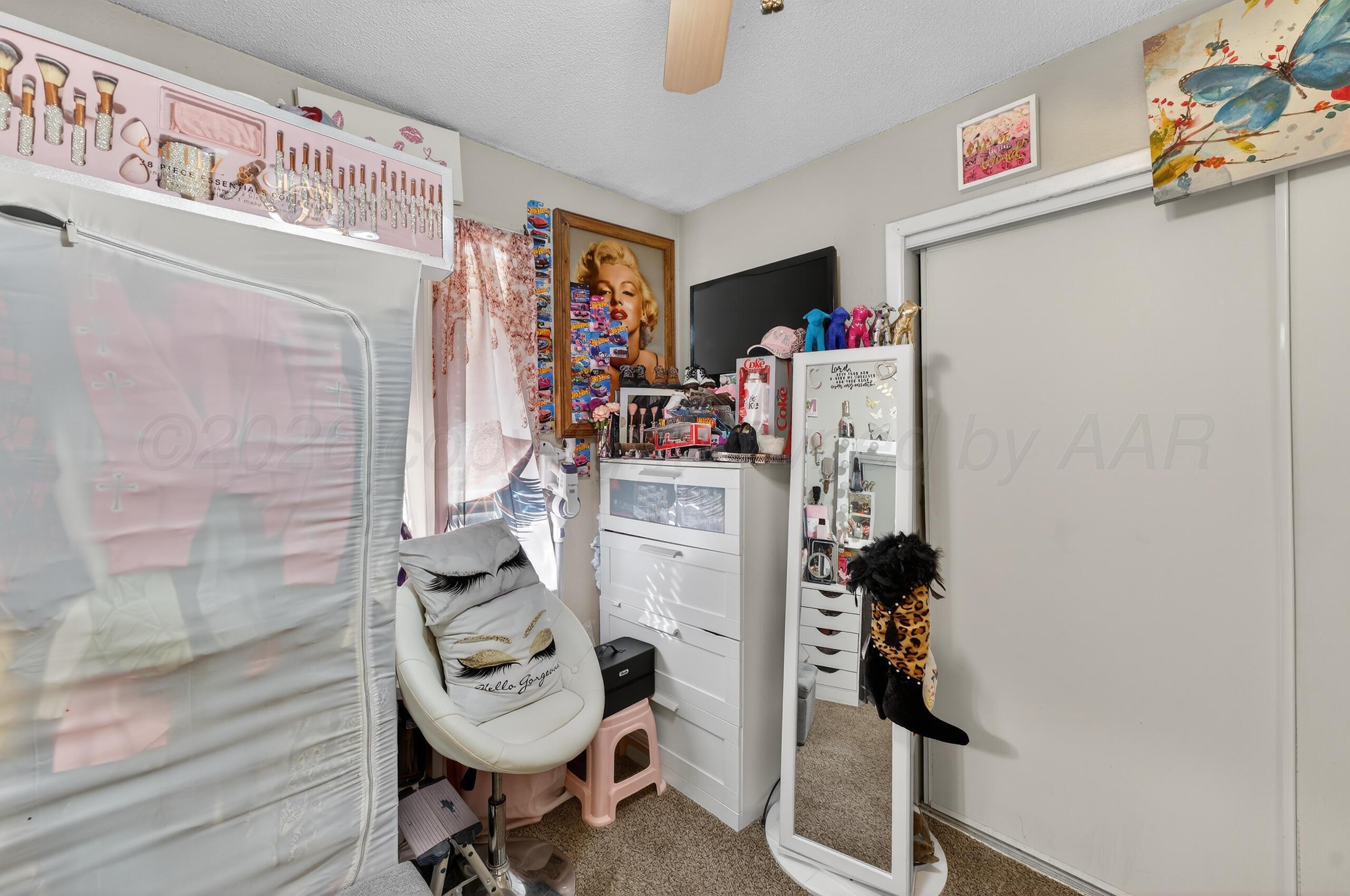 1007 Tudor Drive Amarillo, TX 79104 - Photo 19 of 27 a view of walk in closet with clothes and shoes