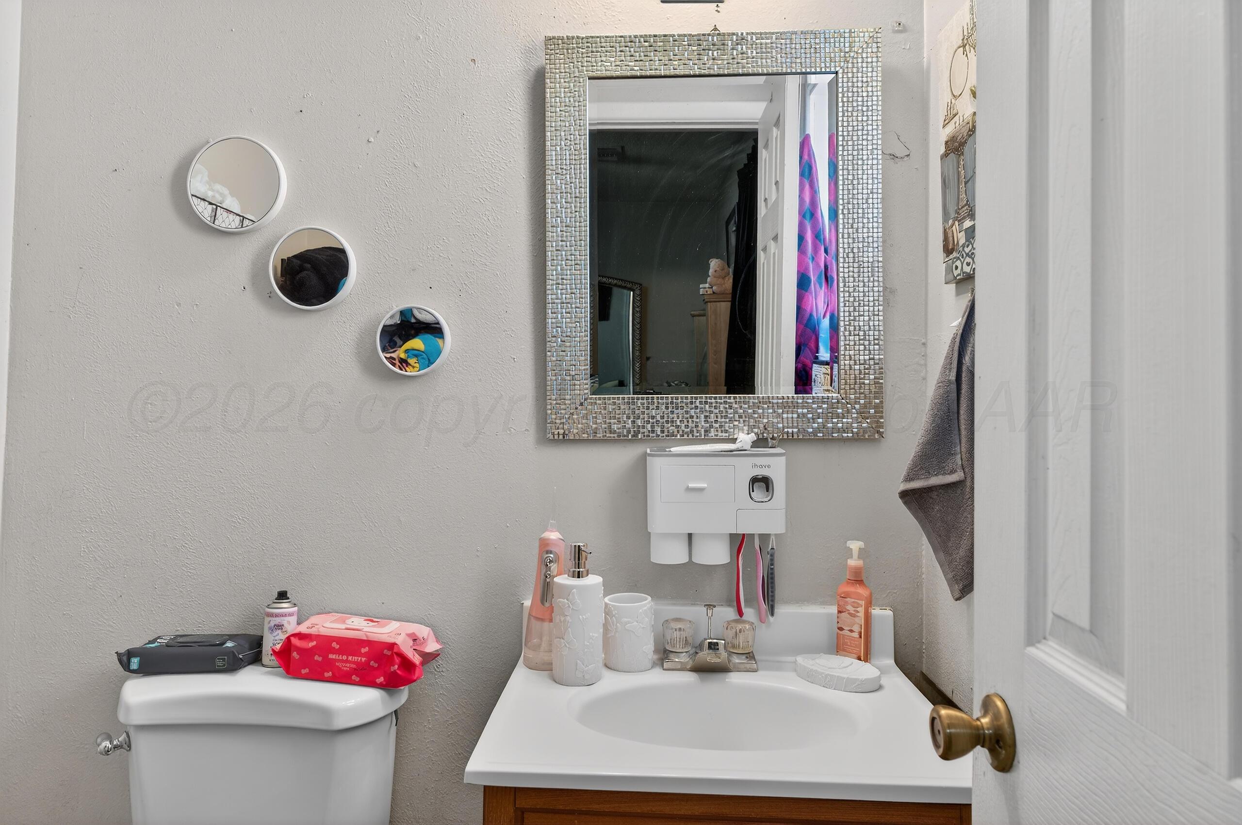 1007 Tudor Drive Amarillo, TX 79104 - Photo 21 of 27 a bathroom with a sink and a mirror