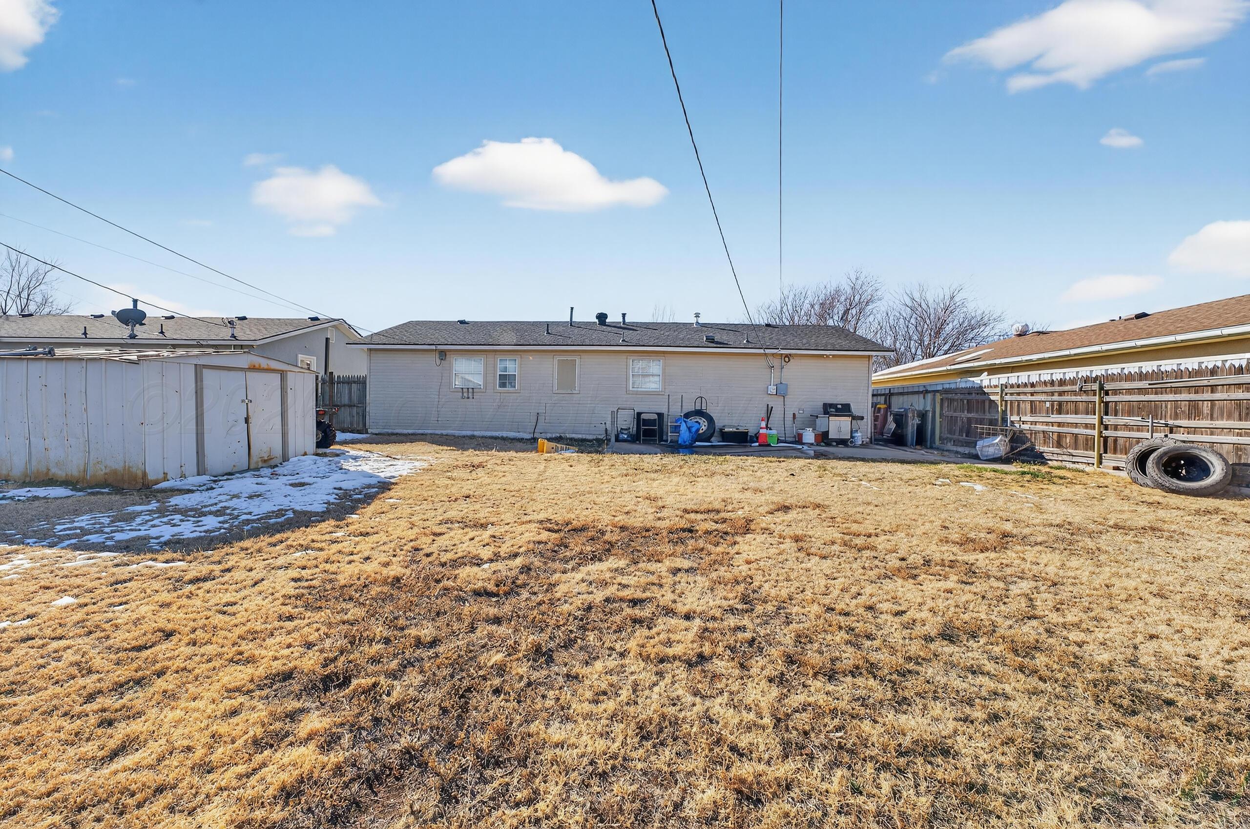 1007 Tudor Drive Amarillo, TX 79104 - Photo 26 of 27 a view of a house with a yard