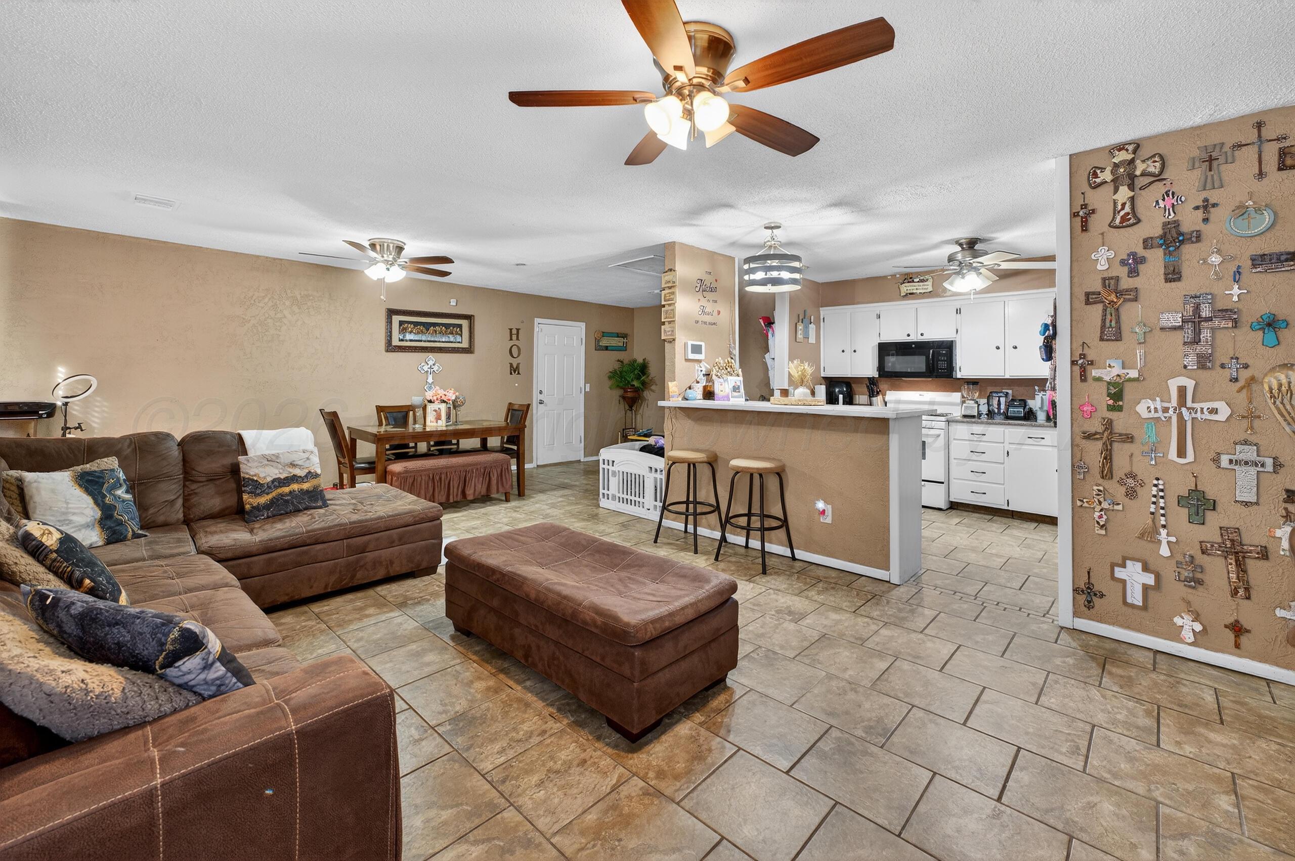 1007 Tudor Drive Amarillo, TX 79104 - Photo 3 of 27 a living room with furniture and a chandelier
