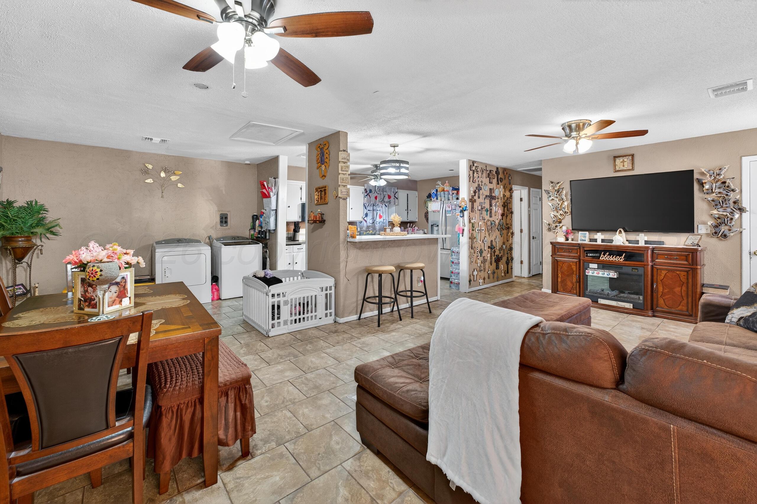1007 Tudor Drive Amarillo, TX 79104 - Photo 4 of 27 a living room with furniture a flat screen tv and a fireplace