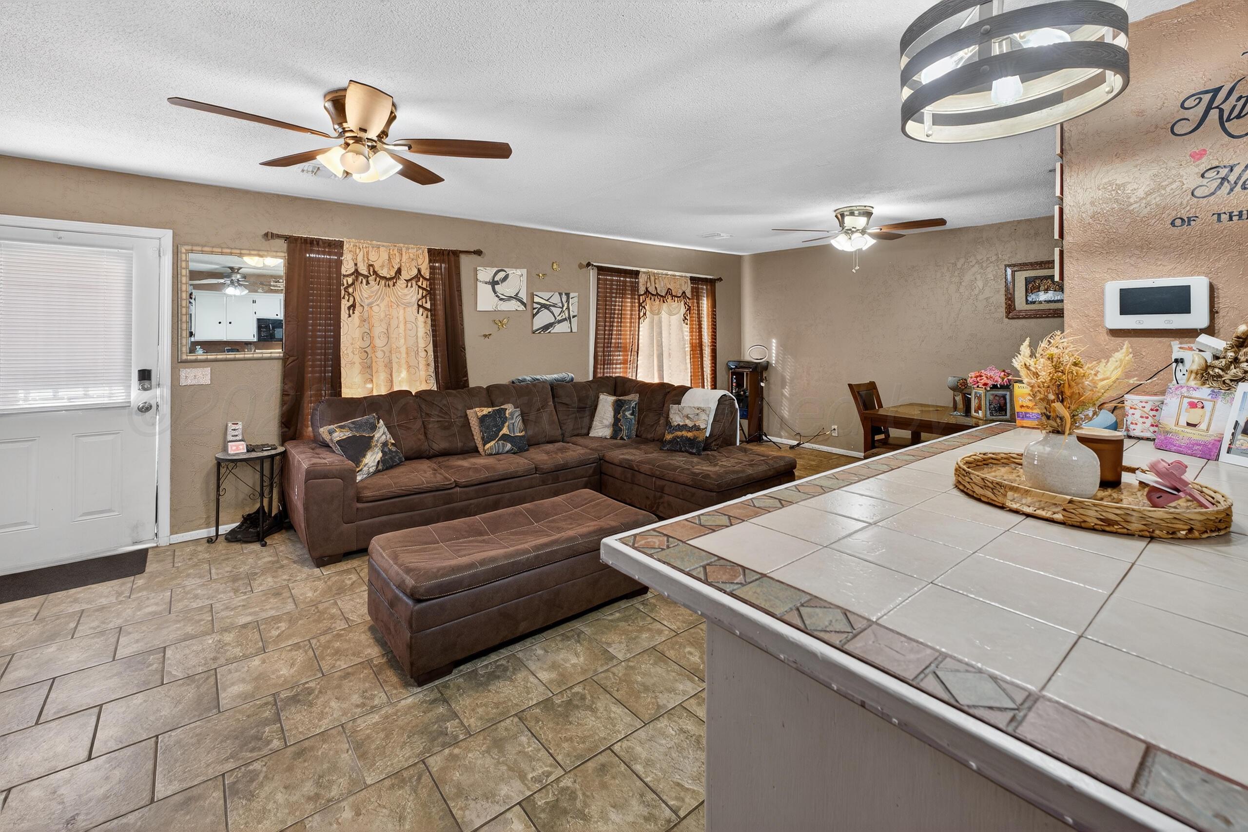 1007 Tudor Drive Amarillo, TX 79104 - Photo 6 of 27 a living room with furniture and a chandelier