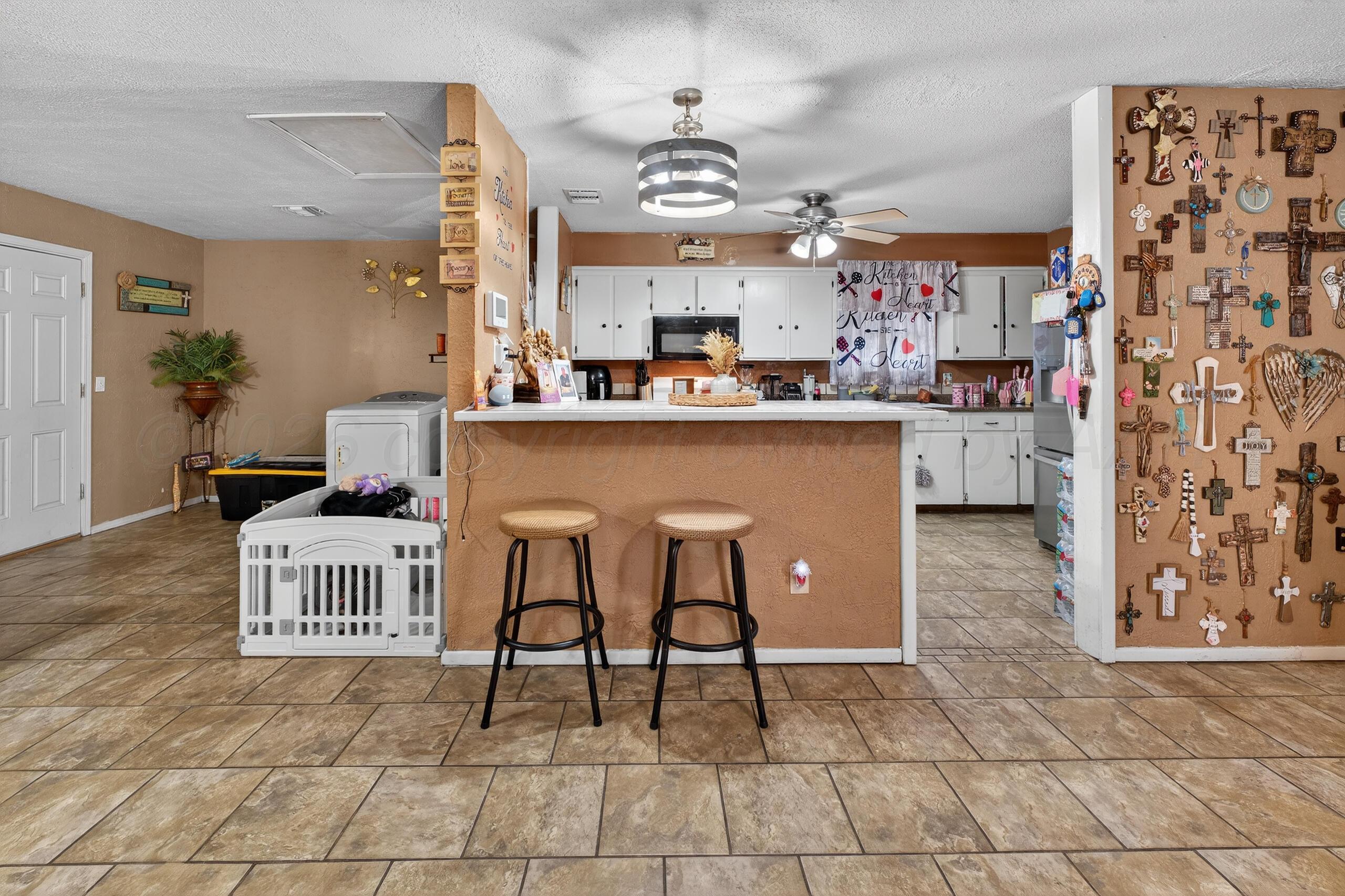 1007 Tudor Drive Amarillo, TX 79104 - Photo 9 of 27 a kitchen with stainless steel appliances granite countertop a refrigerator and a stove top oven
