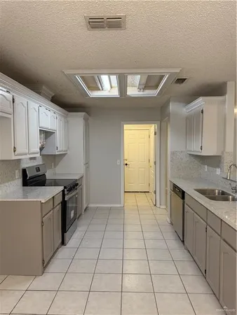a kitchen with stainless steel appliances granite countertop a sink and cabinets