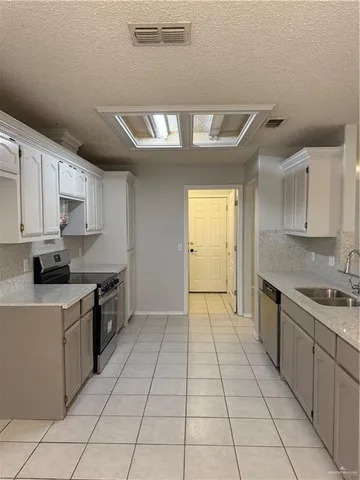 a kitchen with stainless steel appliances granite countertop a sink and cabinets