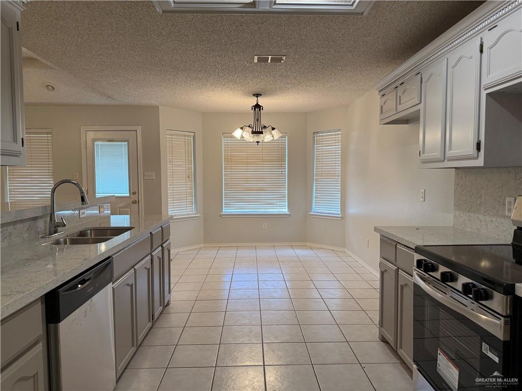 2517 Emory Avenue, Unit 60 McAllen, TX 78504 - Photo 5 of 12 a kitchen with a sink stove and cabinets