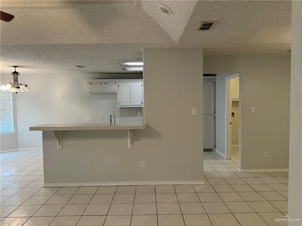 an empty room with closet and mirror