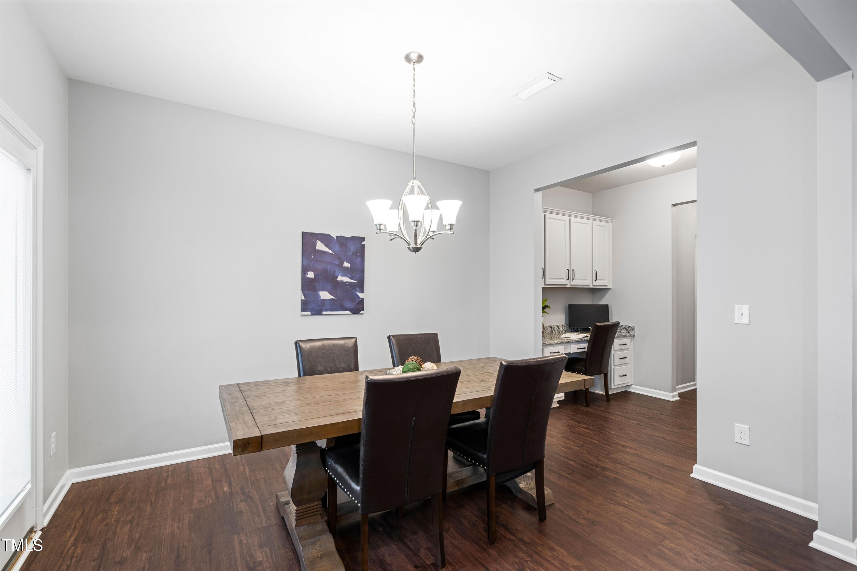 624 Metro Station Apex, NC 27502 - Photo 11 of 36 a view of a dining room with furniture wooden floor and a chandelier