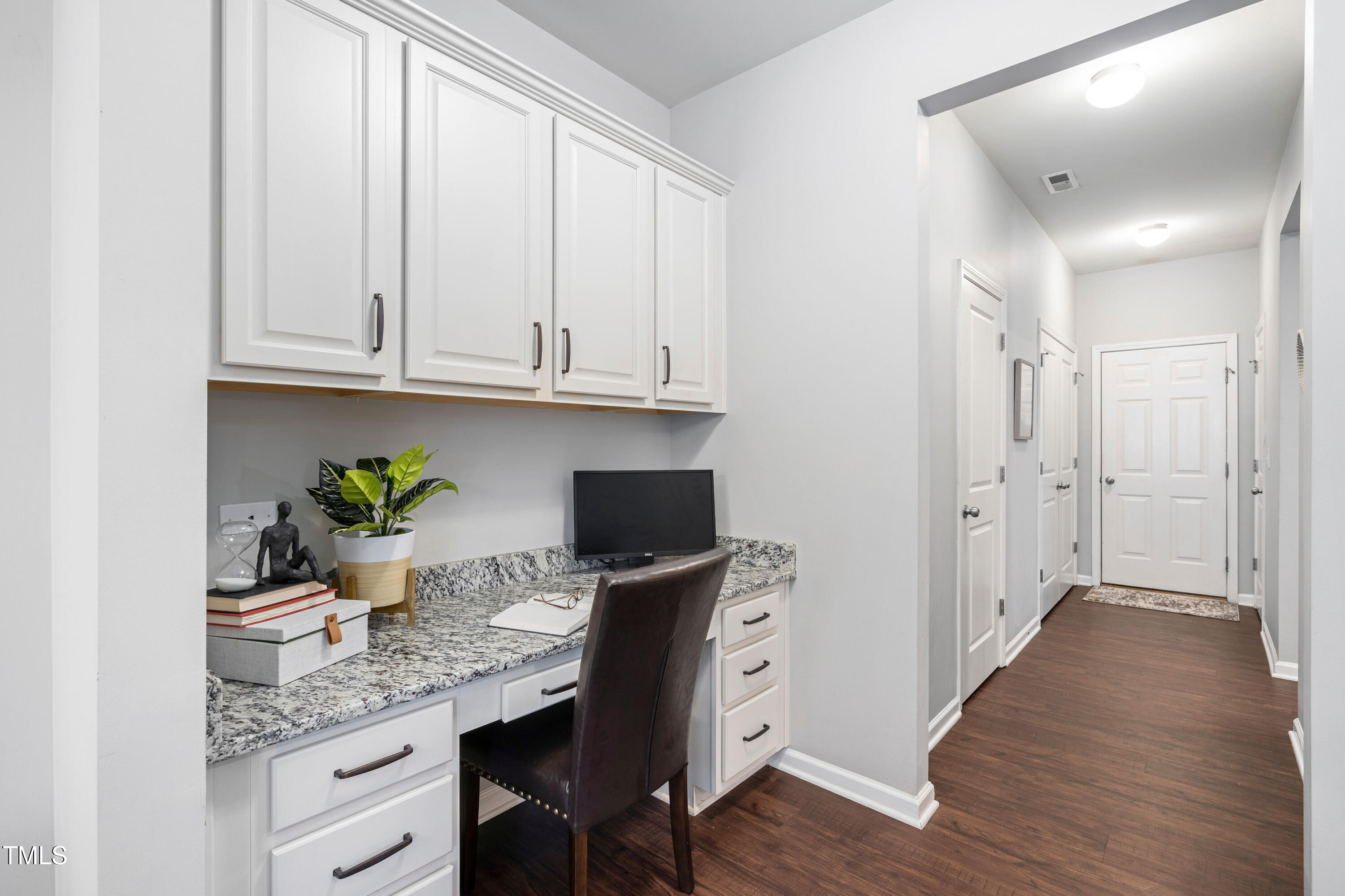 624 Metro Station Apex, NC 27502 - Photo 13 of 36 a kitchen with stainless steel appliances granite countertop a refrigerator a sink dishwasher and white cabinets with wooden floor