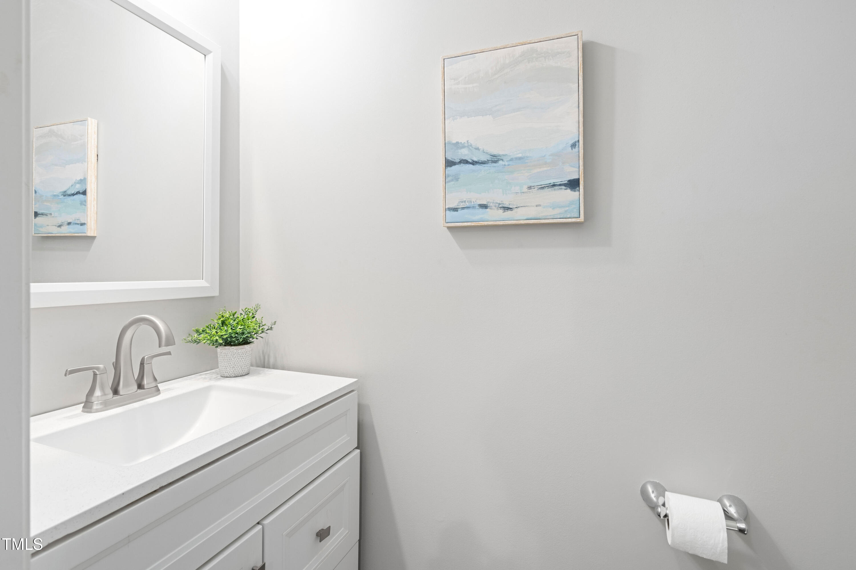 624 Metro Station Apex, NC 27502 - Photo 15 of 36 a bathroom with a sink and a mirror