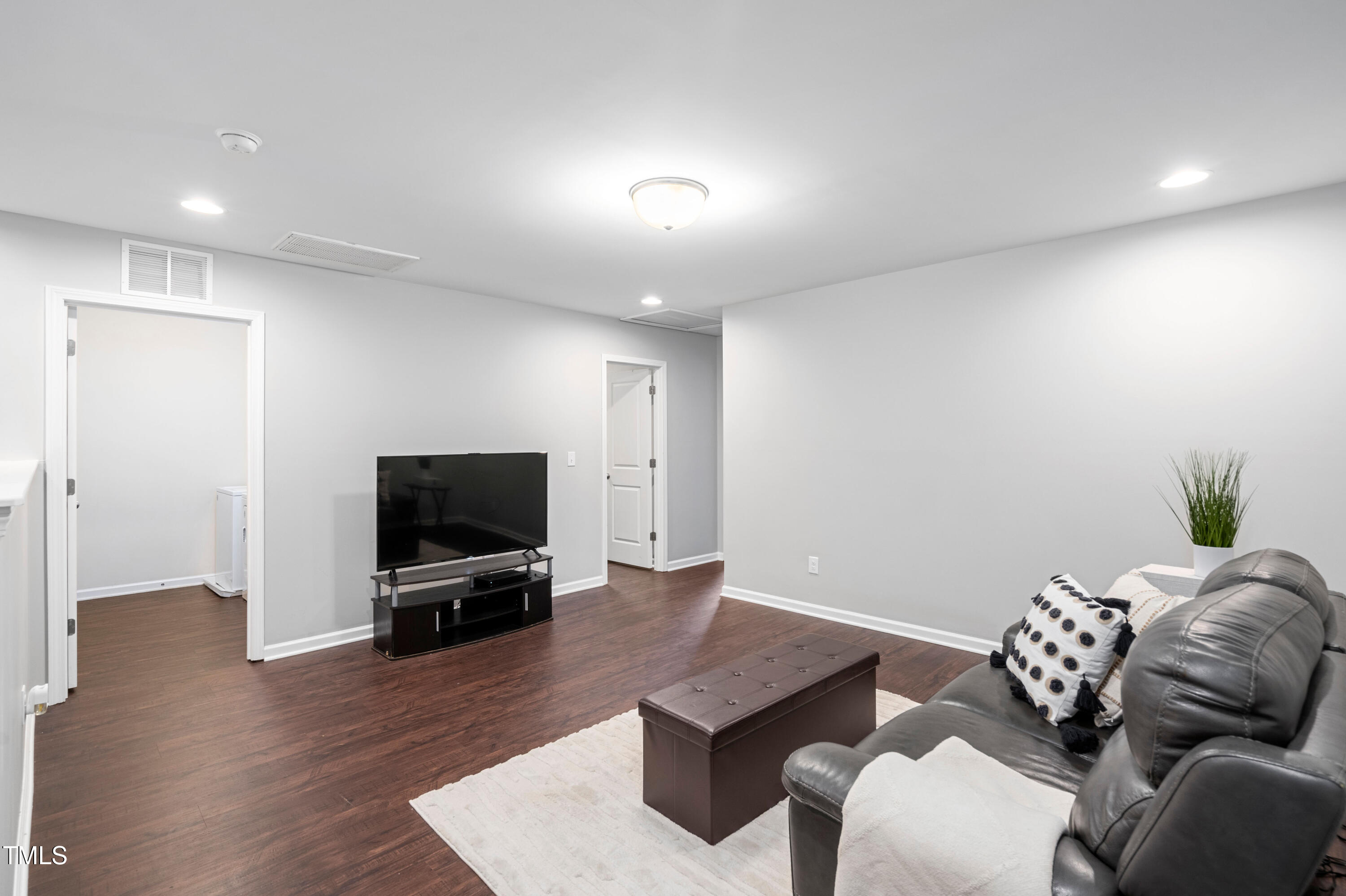 624 Metro Station Apex, NC 27502 - Photo 16 of 36 a living room with furniture and a flat screen tv