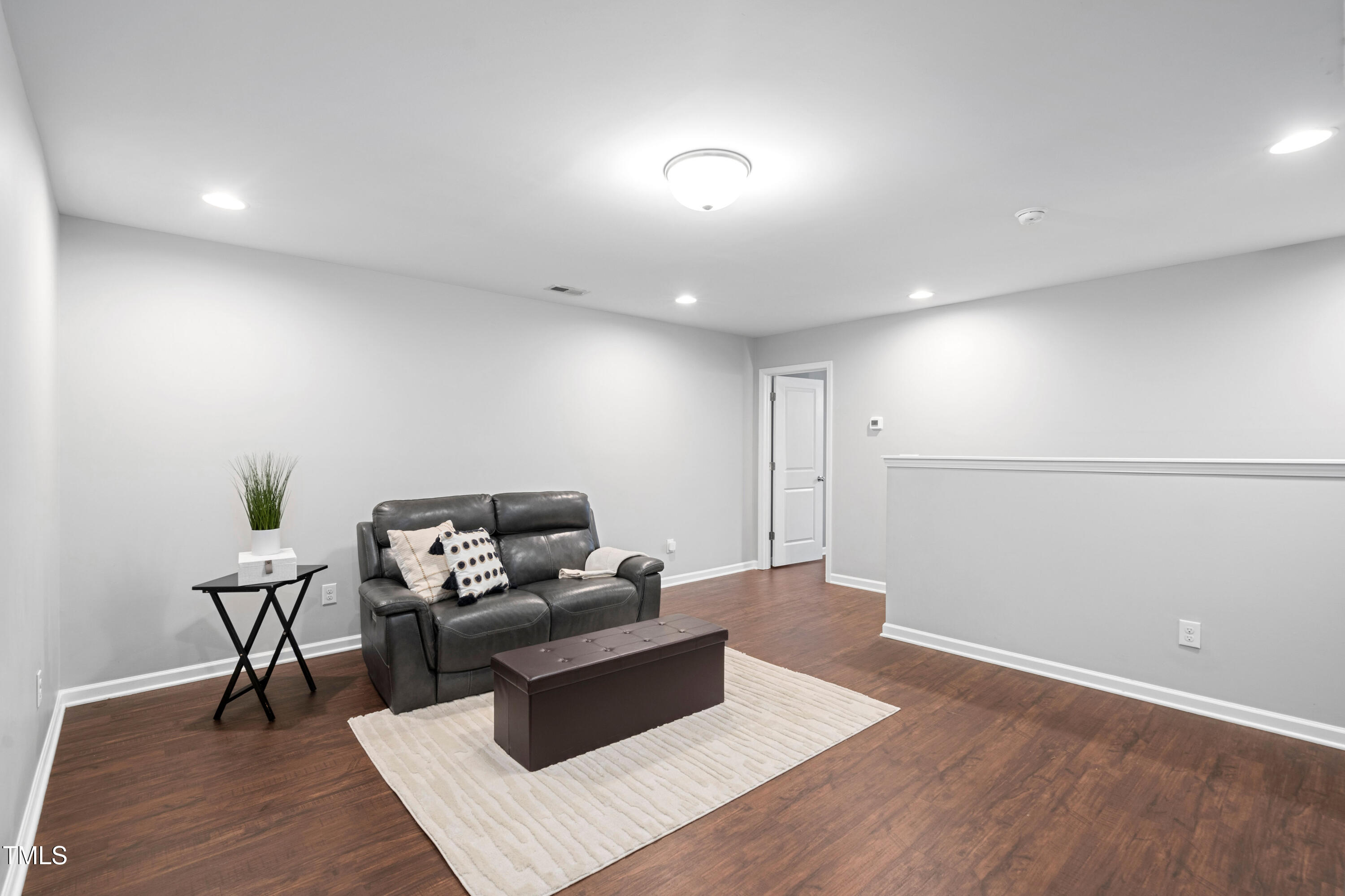 624 Metro Station Apex, NC 27502 - Photo 17 of 36 a living room with furniture and wooden floor