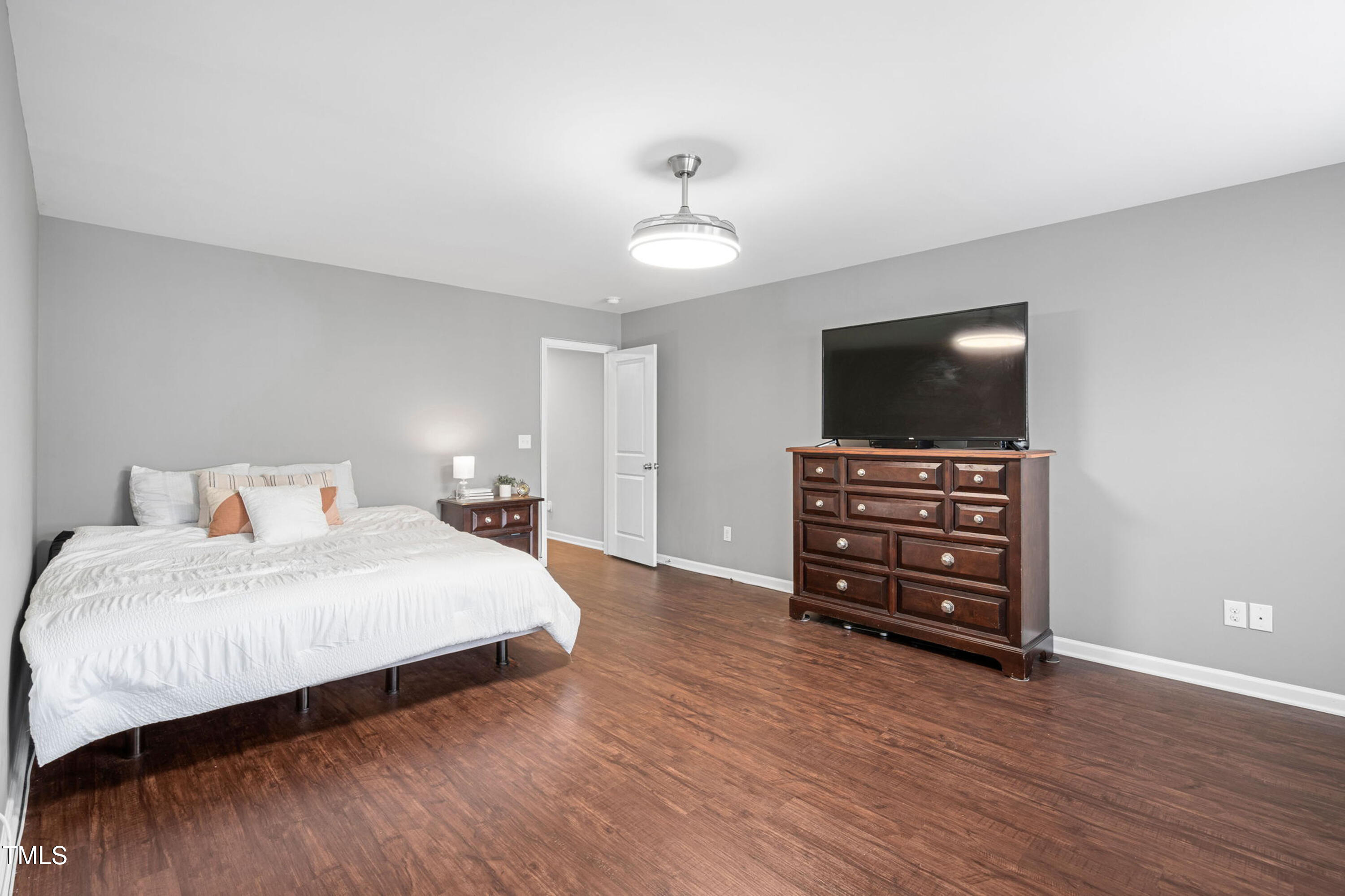 624 Metro Station Apex, NC 27502 - Photo 19 of 36 a bedroom with a bed and a flat screen tv