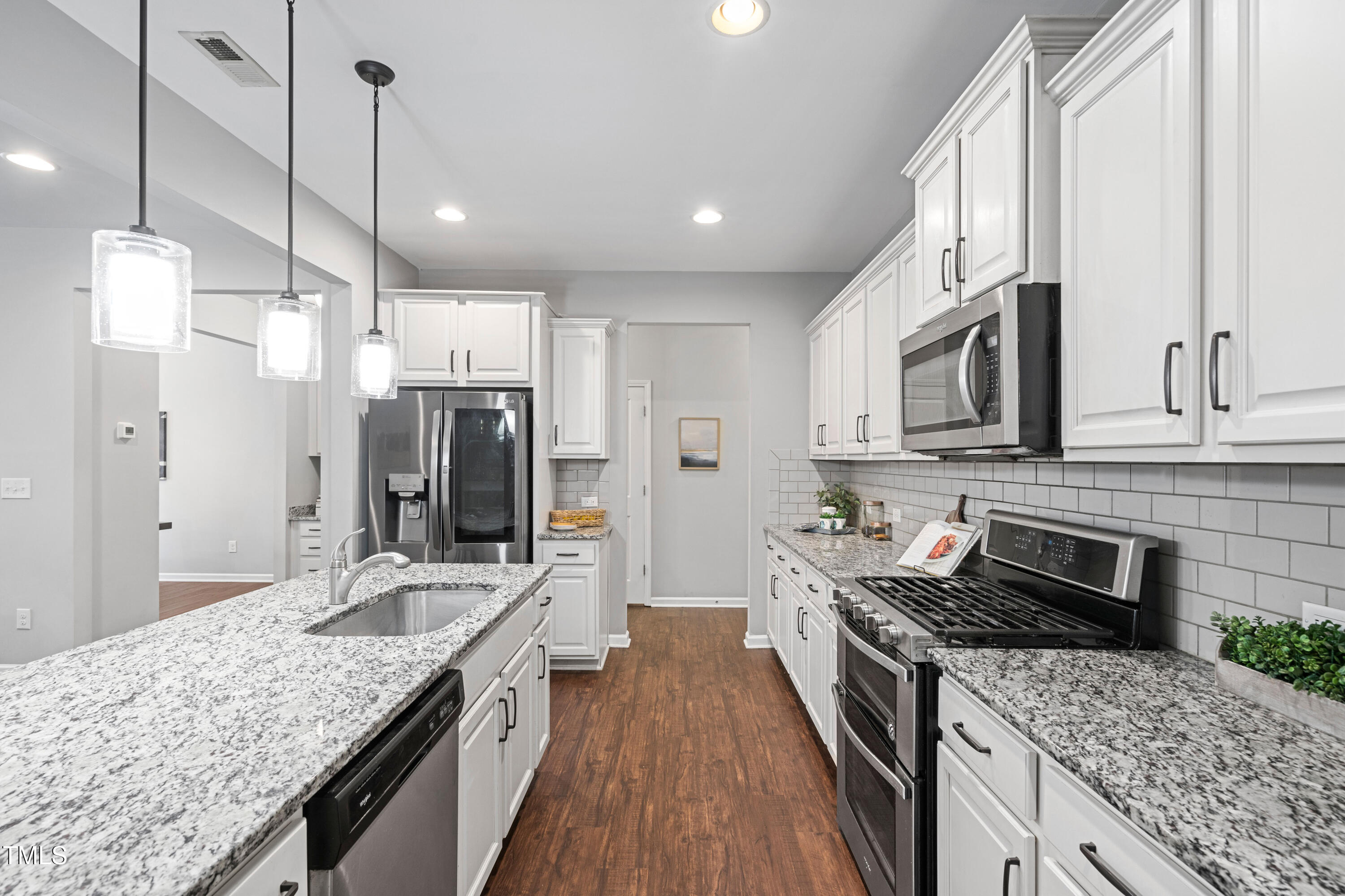 624 Metro Station Apex, NC 27502 - Photo 2 of 36 a kitchen with stainless steel appliances granite countertop a sink stove and refrigerator