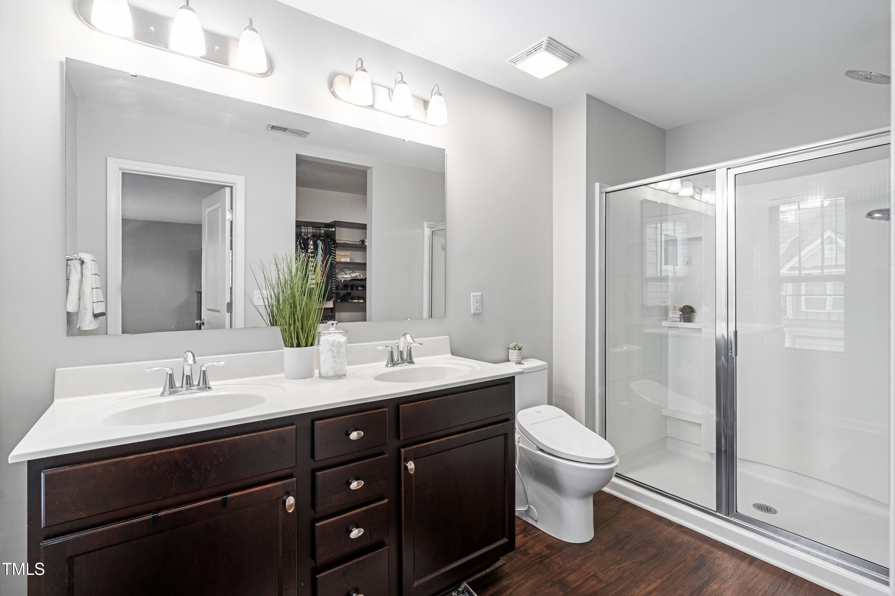 624 Metro Station Apex, NC 27502 - Photo 22 of 36 a bathroom with a double vanity sink toilet and shower