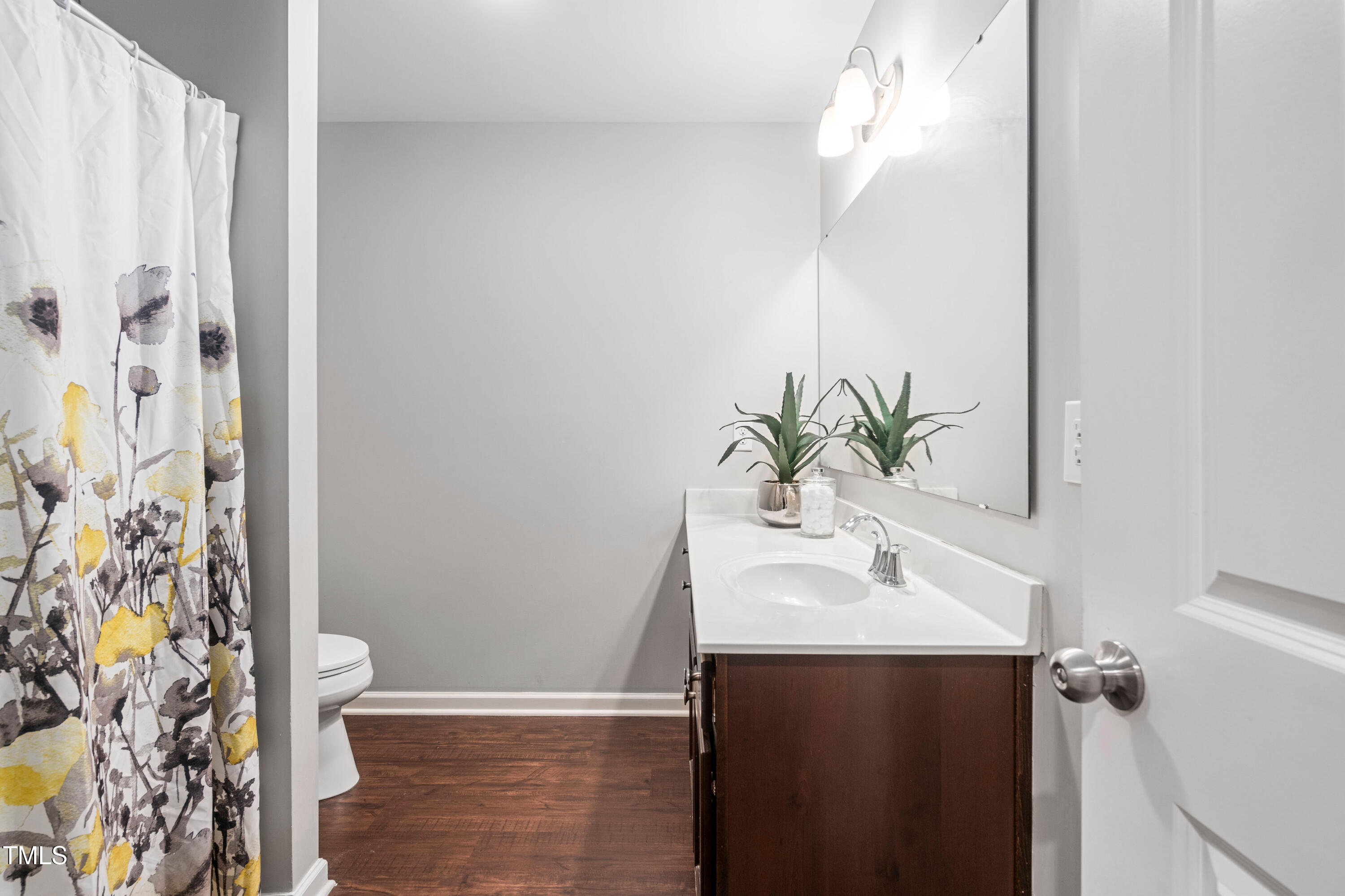 624 Metro Station Apex, NC 27502 - Photo 24 of 36 a bathroom with a sink and a mirror