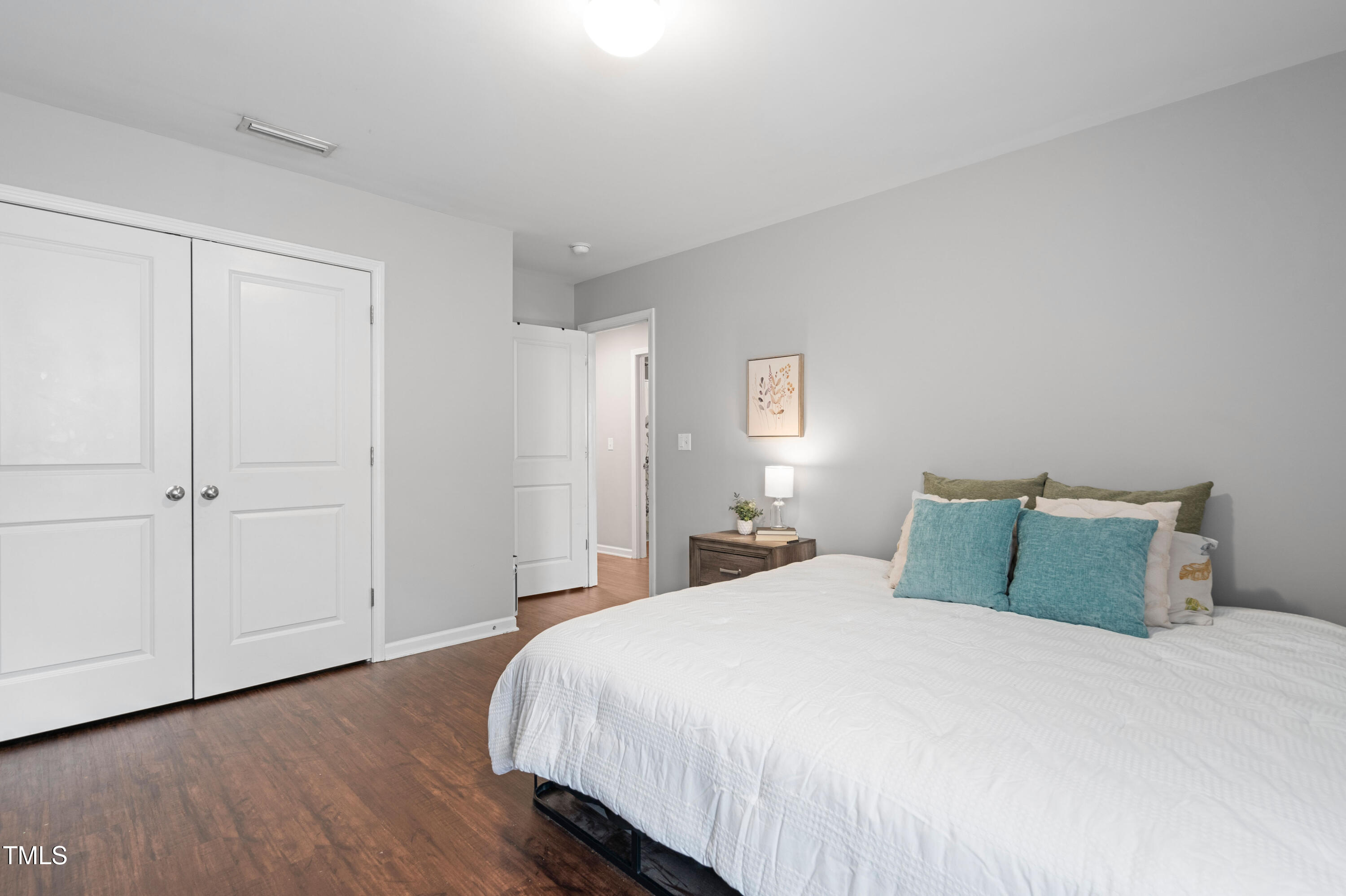 624 Metro Station Apex, NC 27502 - Photo 25 of 36 a bedroom with a bed and wooden floor