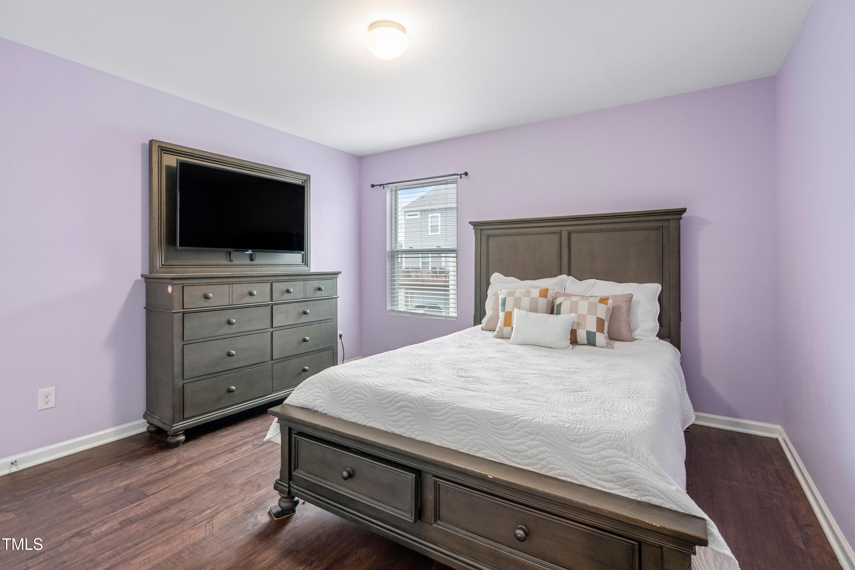 624 Metro Station Apex, NC 27502 - Photo 26 of 36 a bedroom with a bed and wooden floor