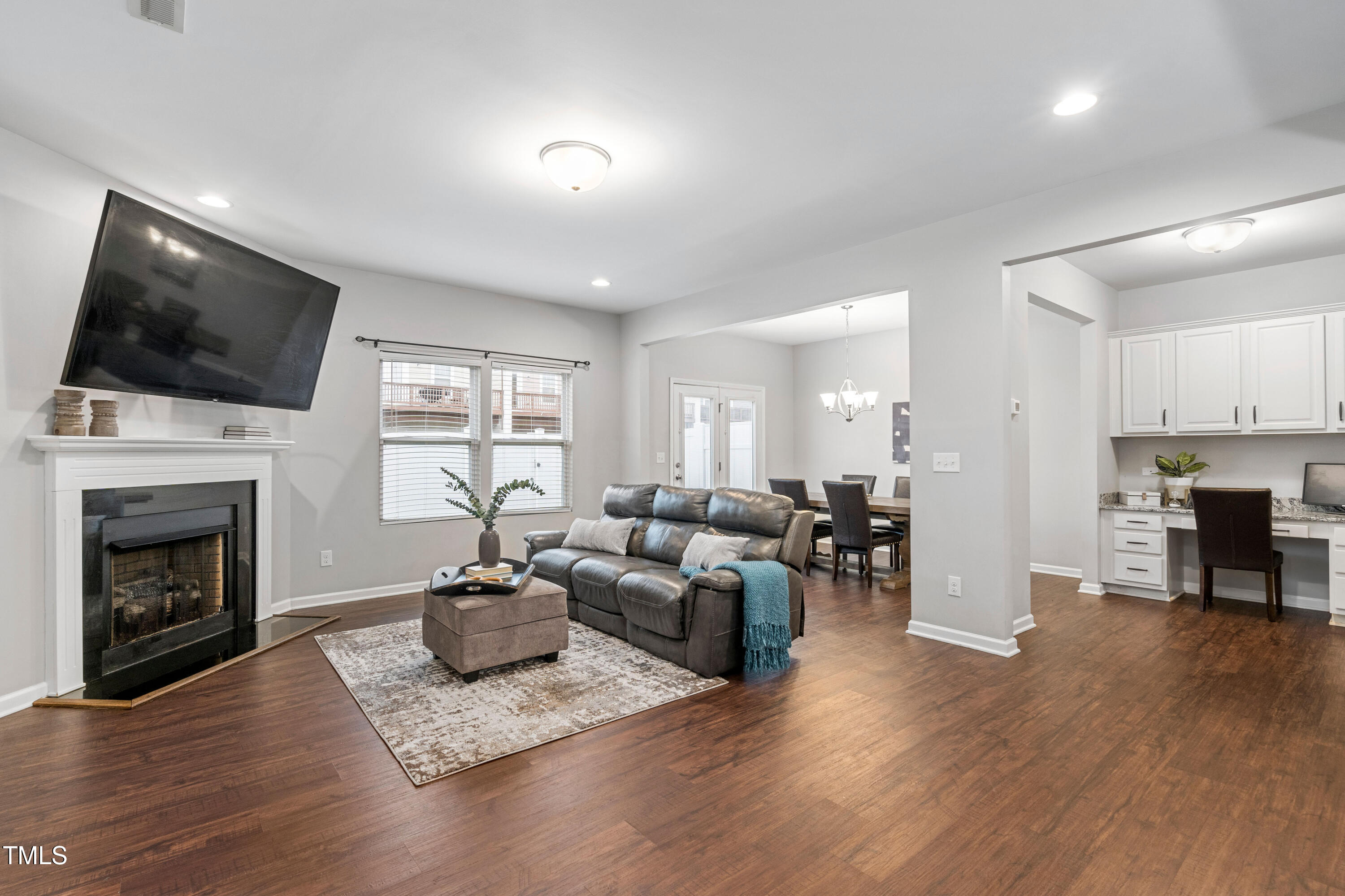 624 Metro Station Apex, NC 27502 - Photo 3 of 36 a living room with furniture a flat screen tv and a fireplace