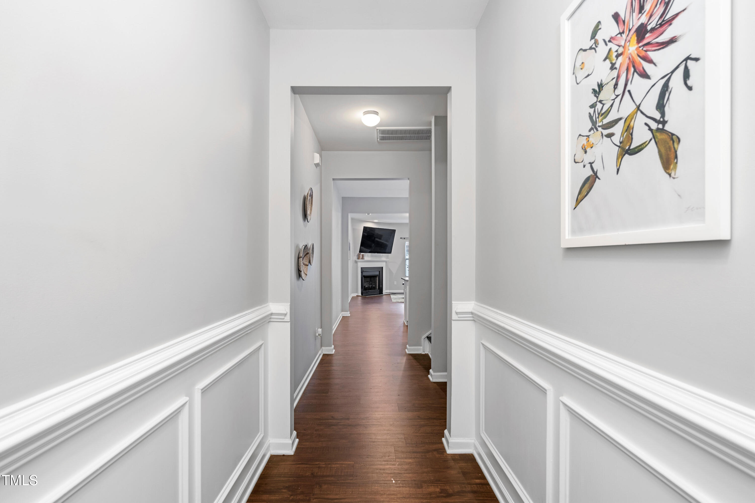 624 Metro Station Apex, NC 27502 - Photo 5 of 36 a view of a hallway with wooden floor and a bathroom