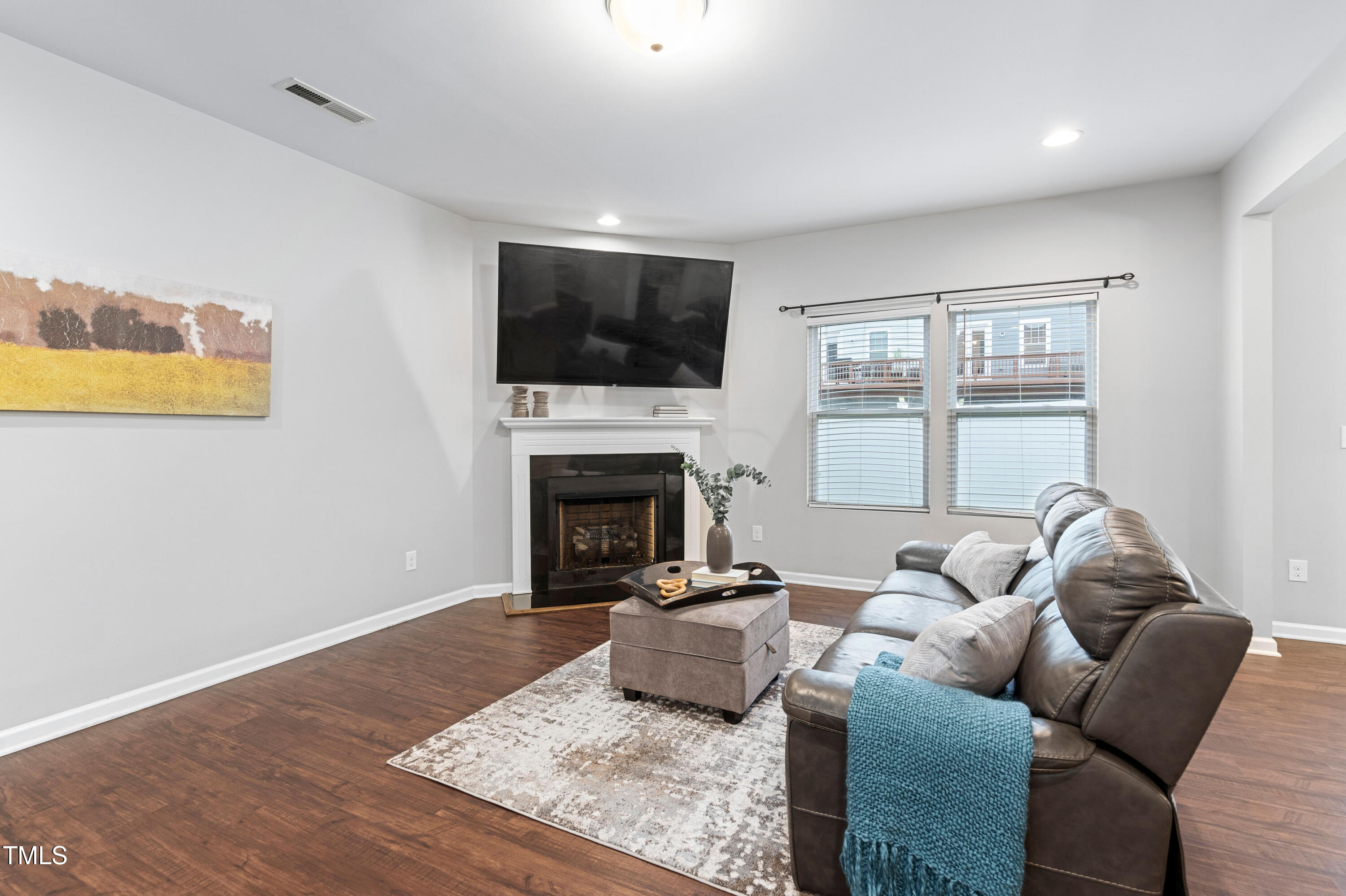 624 Metro Station Apex, NC 27502 - Photo 9 of 36 a living room with furniture or flat screen tv and a fireplace