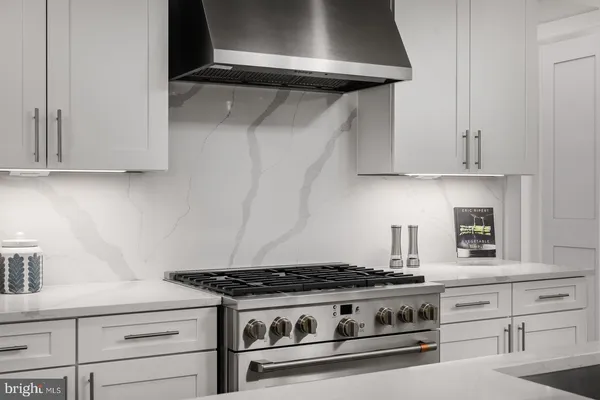 a stove top oven sitting inside of a kitchen