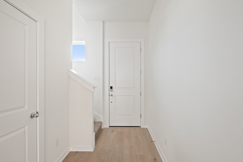 2205 Cento Walk Round Rock, TX 78664 - Photo 3 of 35 Hall with baseboards and light wood-style flooring