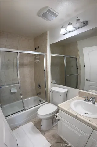 a bathroom with a toilet sink and shower