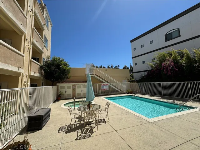 a view of a patio with a table and chairs