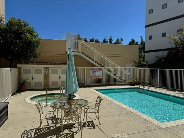 a balcony with table and chairs