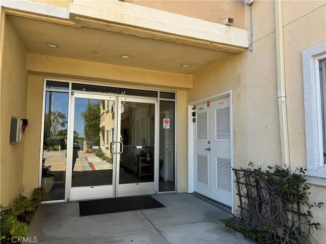 a front view of a building with a garden