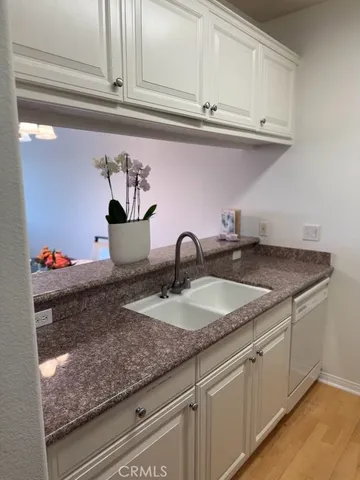 a sink with white cabinets