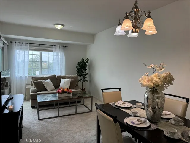 a living room with furniture and chandelier