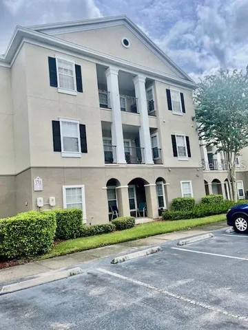 a front view of residential houses with yard and green space