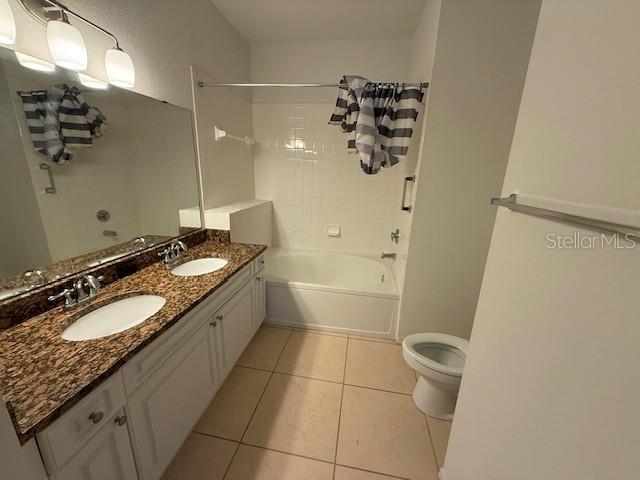 3701 Conroy Road, Unit 1822 Orlando, FL 32839 - Photo 11 of 23 a bathroom with a granite countertop sink toilet and shower