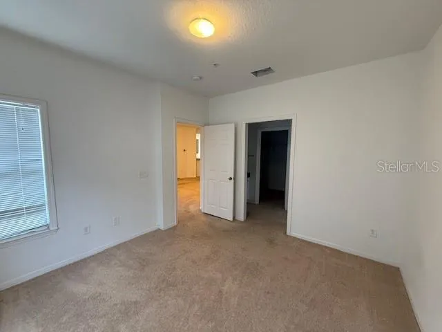 an empty room with closet area