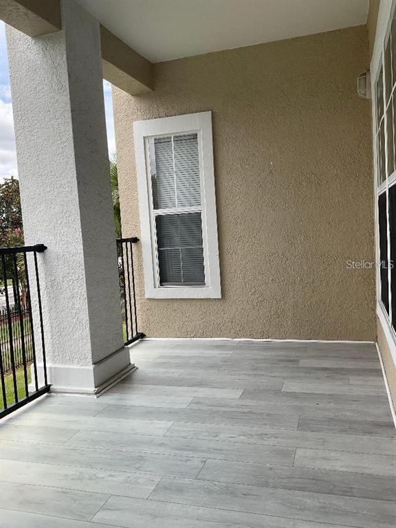 3701 Conroy Road, Unit 1822 Orlando, FL 32839 - Photo 20 of 23 a view of an empty room with wooden floor and a window