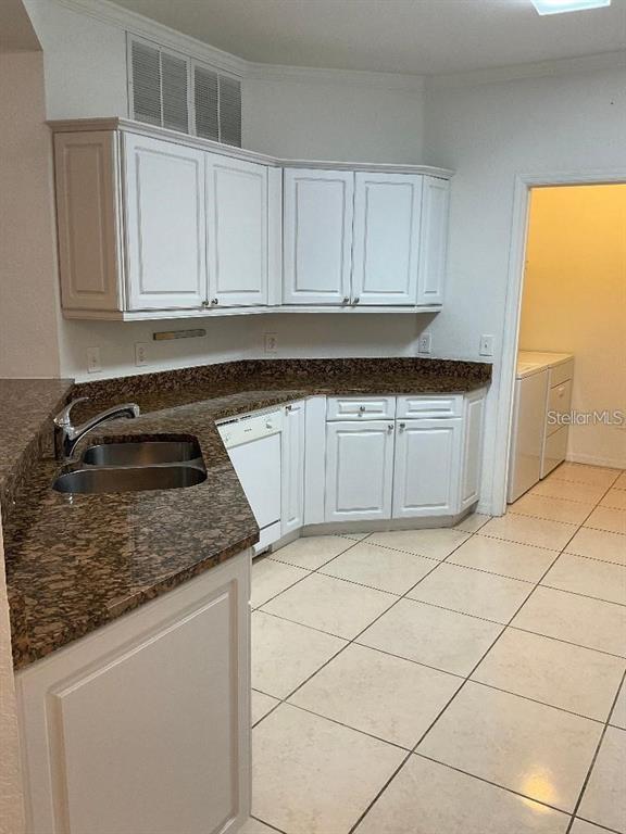 3701 Conroy Road, Unit 1822 Orlando, FL 32839 - Photo 6 of 23 a kitchen with granite countertop white cabinets and stainless steel appliances