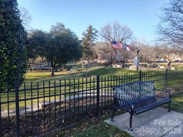 a view of a swimming pool a yard and outdoor seating